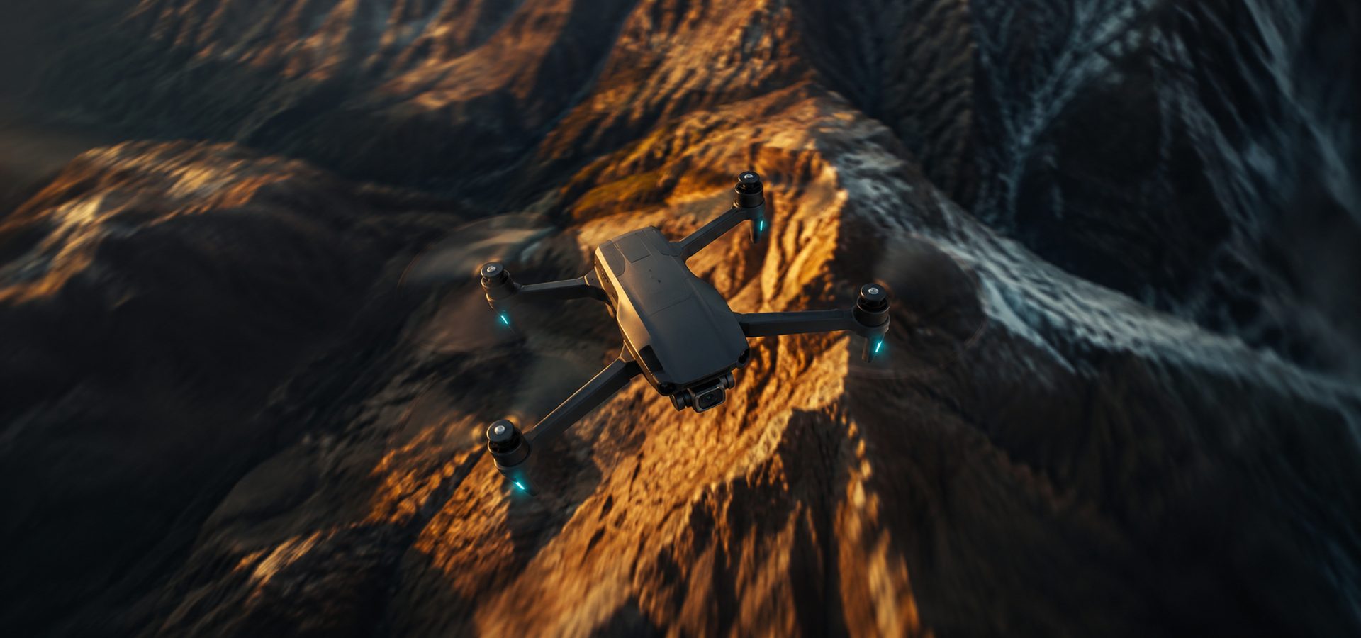 Drone flying over dramatic mountain terrain at golden hour
